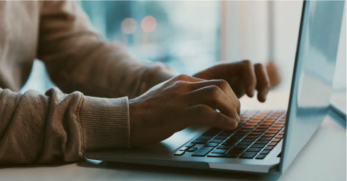 Person writing in a computer.